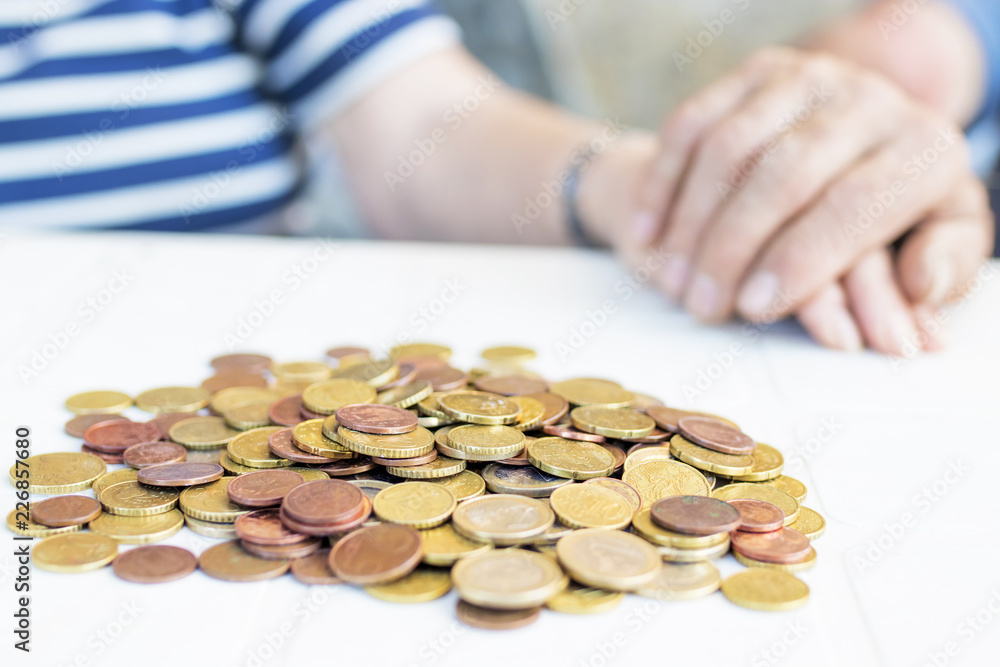 seniors couple hands with heaped money, pensions and savings seniors couple hands with heaped money, pensions and savings