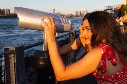 Two women looking through viewer at New York