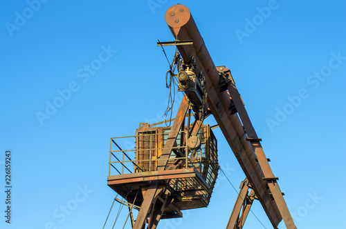 gantry crane, telpher, old, ancient, past, broken, abandoned, rusty, closed production, work; orange; metal; environment; vintage; old; ancient; past; broken; abandoned; rusty; closed production photo