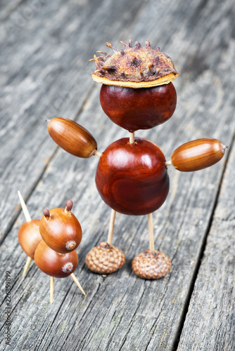 Small creature made of chestnuts and acorns. Autumnal decoration