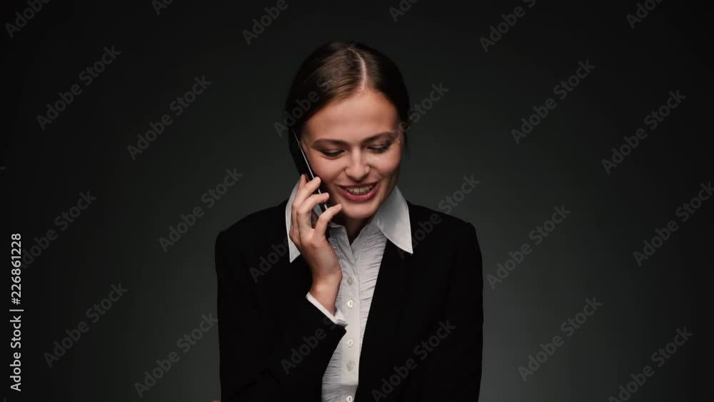 Attractive brunette bussines woman talking on phone and smiling Attractive brunette bussines woman talking on phone and smiling