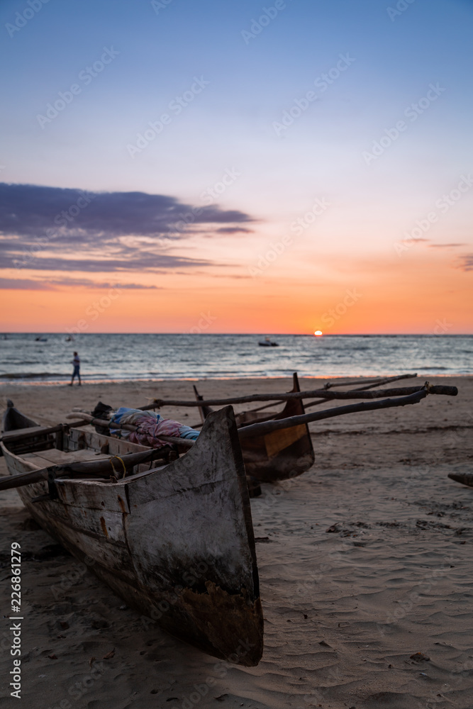 Madagascan pirogue boats at sunset on Nosy Be, Madagascar. Madagascan pirogue boats at sunset on Nosy Be, Madagascar.