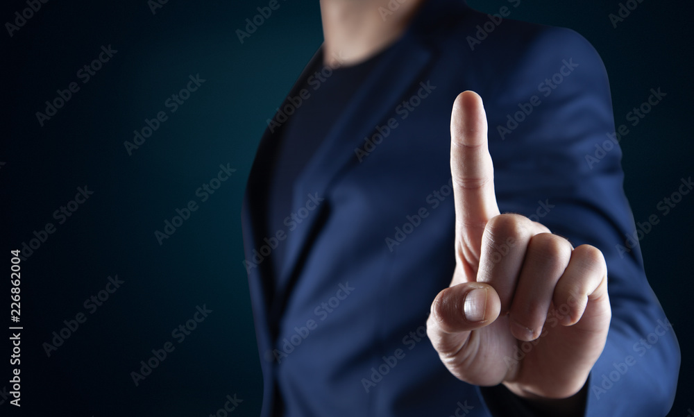 Businessman pressing button on virtual screen Businessman pressing button on virtual screen