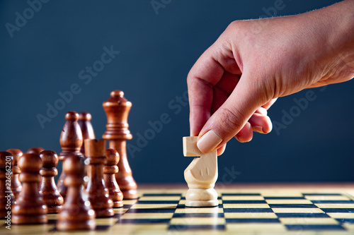 businesswoman playing a game of chess
