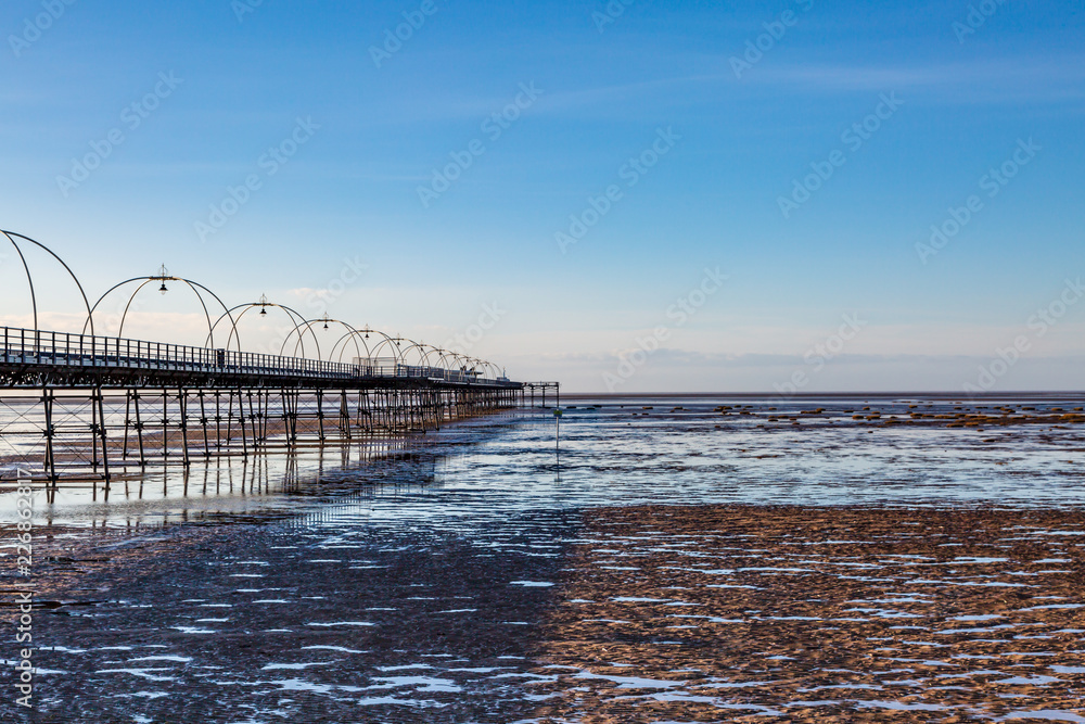 Southport beach and the old pier, at low tide on a sunny evening
