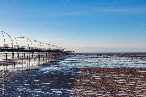 Southport beach and the old pier, at low tide on a sunny evening photo