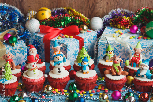 Christmas cupcakes with colored decorations  soft focus background