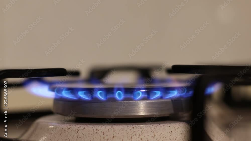 Turning on the cooktop gas cooker. Kitchen burner turning on. Close up