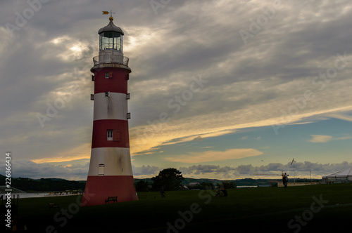Lighthouse in Plymouth in the evening, cloudy dark landscape with last light before sunset, shallow depth of field, Devon England 2018