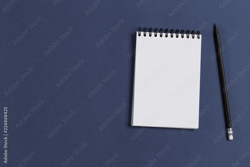 a blank Notepad and pencil on purple background a blank Notepad and pencil on purple background