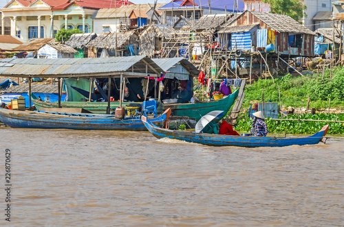 Wallpaper Mural Three women rowing a long-tail boat along the banks of Tonle Sap Lake Torontodigital.ca