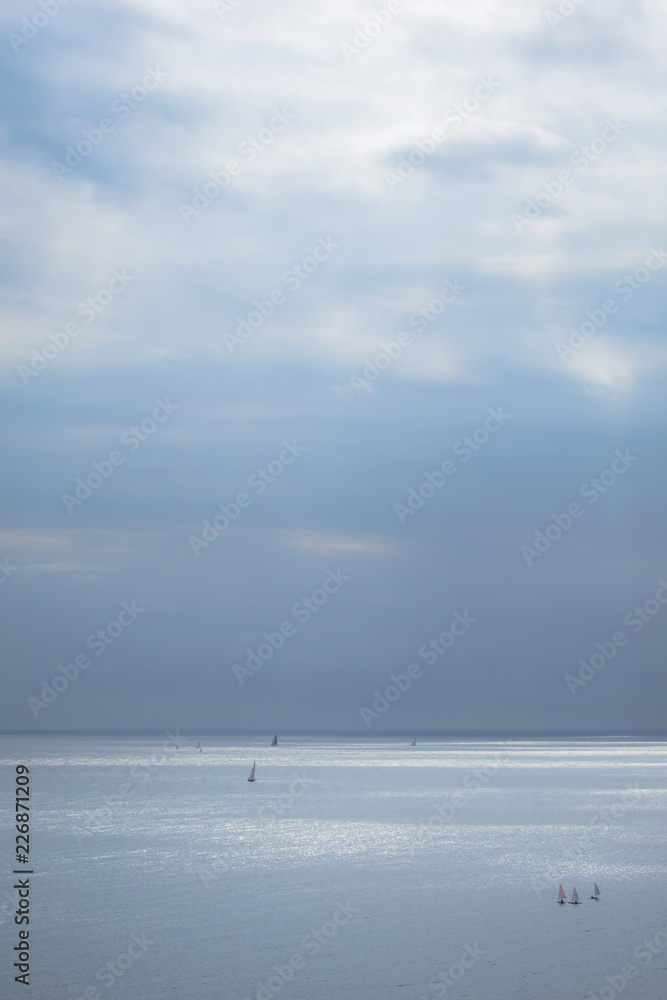 Calm blue sea with sailboats