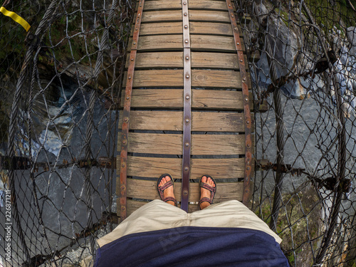 Man on bridge at he Changchun Trail at Taroko Gorge National Park in Taiwan photo