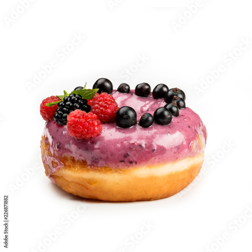 Donut with pink cream and berries  isolated on white background. View from side.