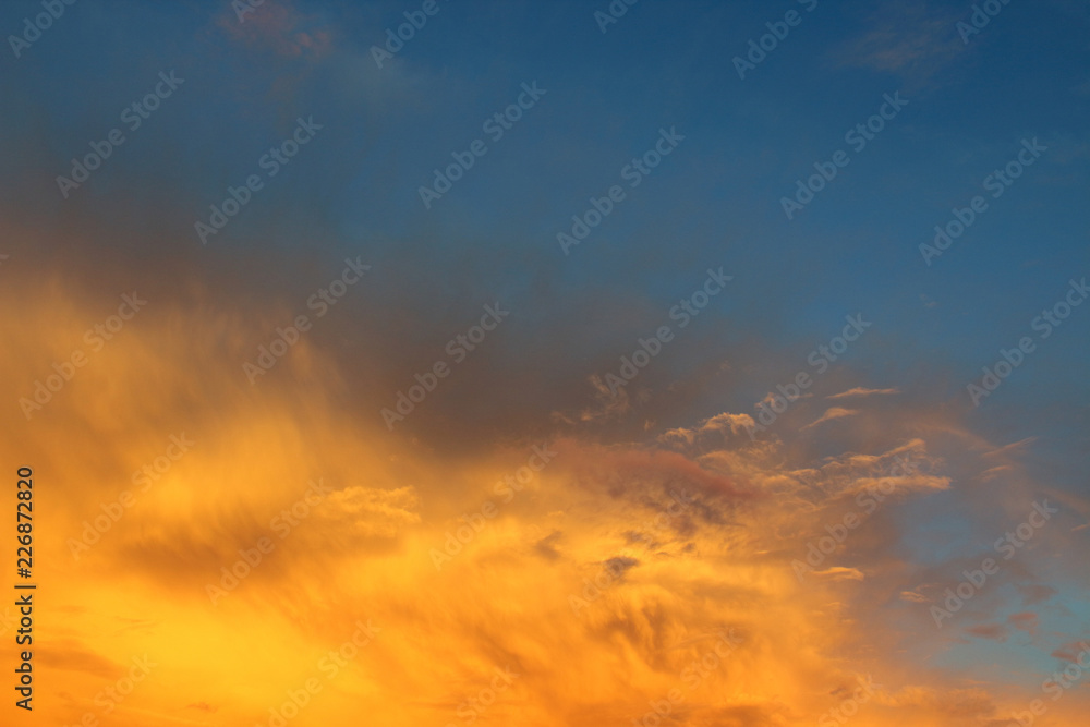 Beautiful blue sky and red cirrus and cumulus clouds. Background. Landscape.