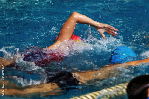 Sports background for splash topics - Sport swimming in the pool. Unsharp background on sports theme of a healthy lifestyle - swimming in the pool