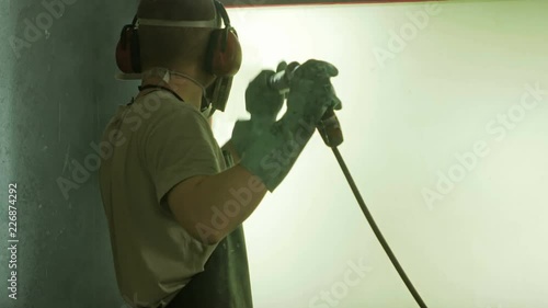 Silk screen printing process - cleaning a screen with water.