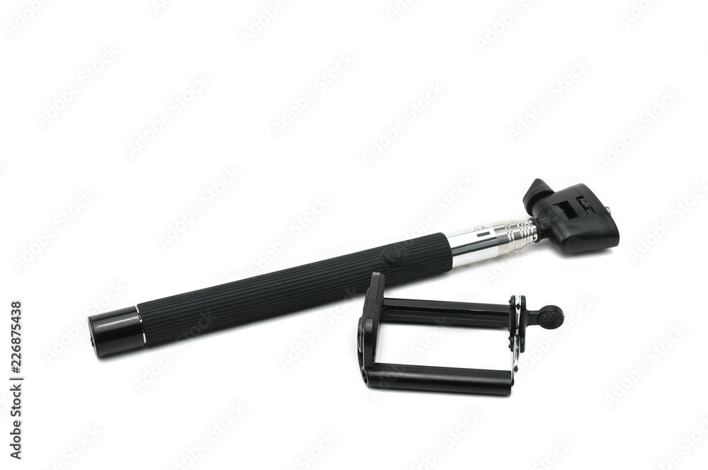 Selfie stick and smartphone on an isolated white background Selfie stick and smartphone on an isolated white background