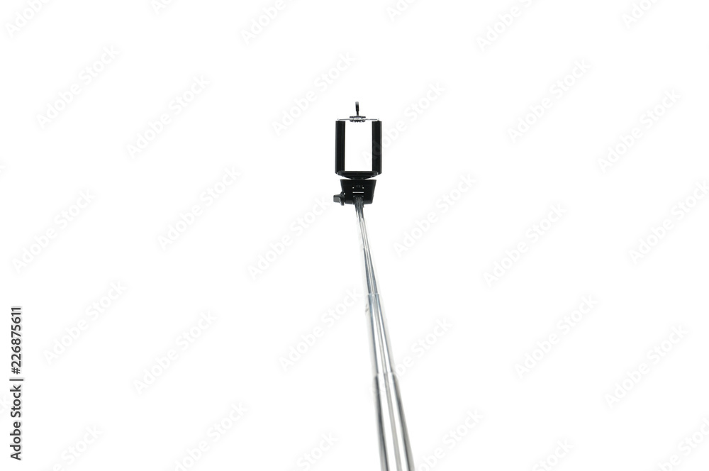 Selfie stick and smartphone on an isolated white background