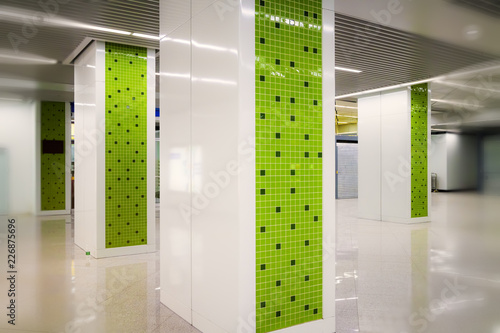 Geometric mosaic pattern on pillar in subway station channel photo