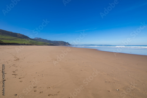 Fototapeta Naklejka Na Ścianę i Meble -  Landscape of beach named La Vega and Cantabrian Sea, with blue sky, in Ribadesella, Asturias, Spain, Europe
