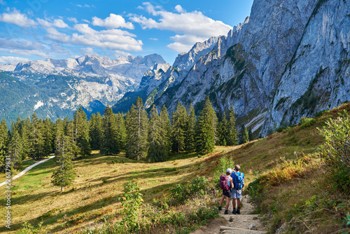 healthy and vital senior couple walking/ makes photo in austrian alps with beautiful view. © Trambitski