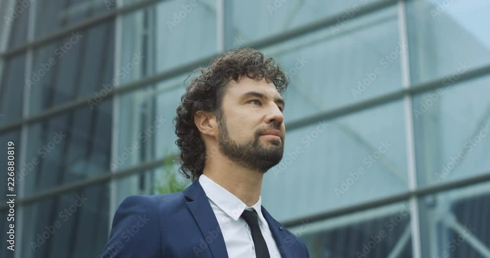 Close up of the young good looking businessman in the tie walking with a bag to the work in the morning. Close up of the young good looking businessman in the tie walking with a bag to the work in the morning.