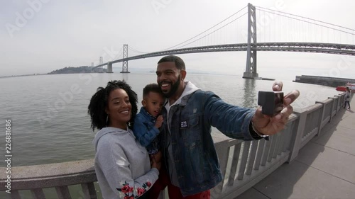 Family takes photo of themselves by Oakland Bay Bridge, POV
