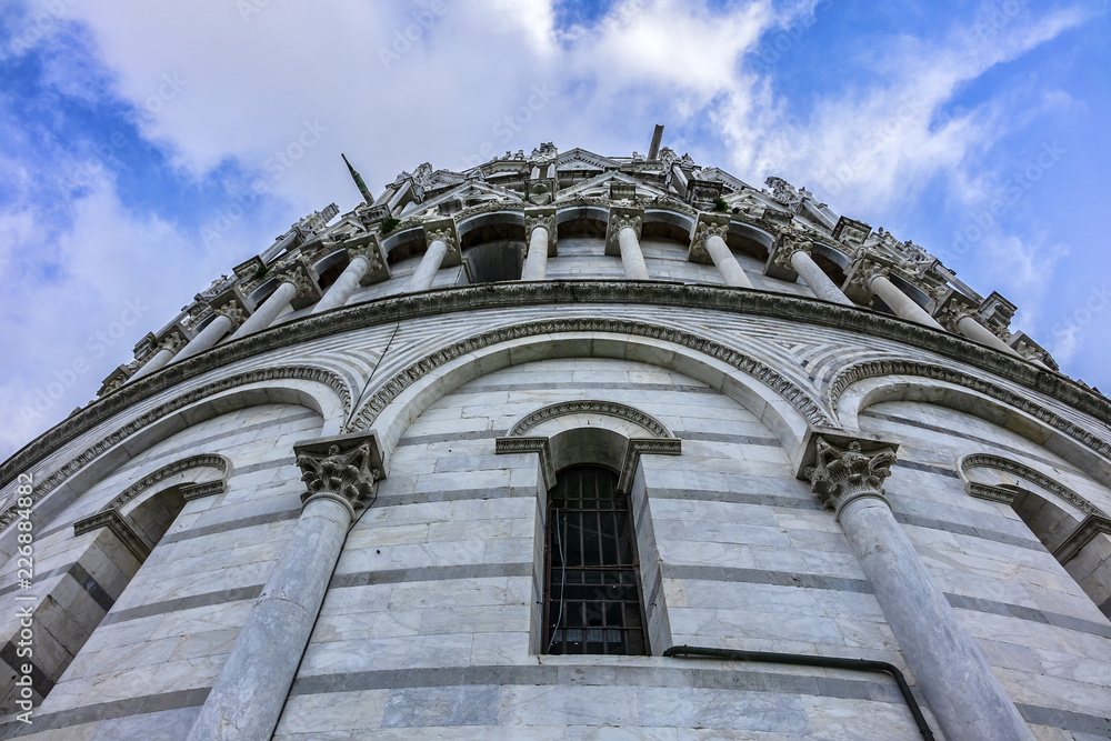 The Baptistery of St. John (Battistero di San Giovanni, 1363) at Piazza dei Miracoli (Square of Miracles) in Pisa. Baptistery is Unesco world heritage site. Pisa, Tuscany, Italy, Europe.