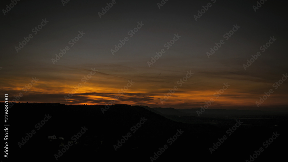 Stunning sunset on the hills between Ostuni and Cisternino with panoramic view on the expanses of olive trees of the plain of Fasano