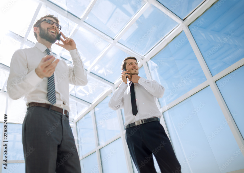 bottom view.business partners are talking on a mobile phone bottom view.business partners are talking on a mobile phone