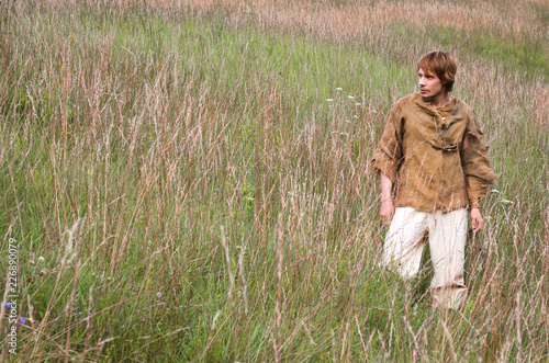 Εκτύπωση καμβά young man dressed as a medieval peasant among wild herbs