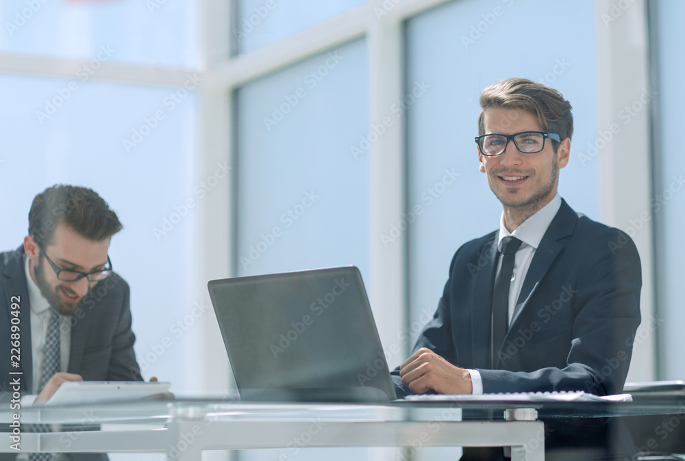 two business people talking sitting at a Desk two business people talking sitting at a Desk