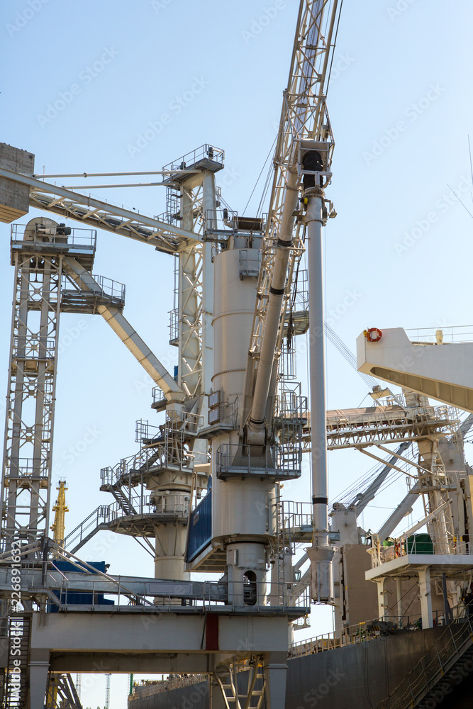 Port grain elevator close up. Industrial sea trading port bulk cargo zone grain terminal Port grain elevator close up. Industrial sea trading port bulk cargo zone grain terminal