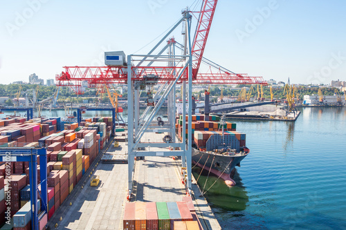 Container ship in port at container terminal. Ships of container ships stand in terminal of port on loading, unloading container.