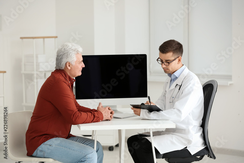 Male doctor consulting pati...
