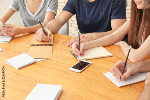 Group of young people writi...