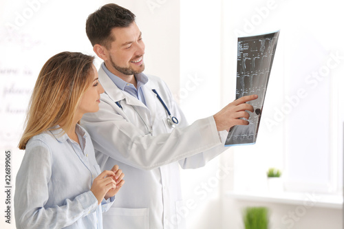 Doctor consulting female pa...