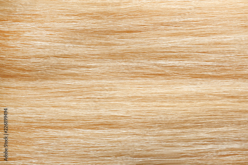 Texture of healthy blond hair as background, closeup