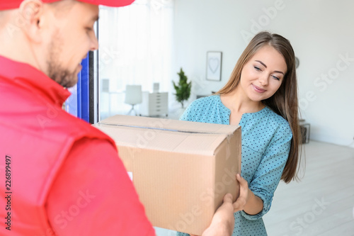 Young woman receiving parce...