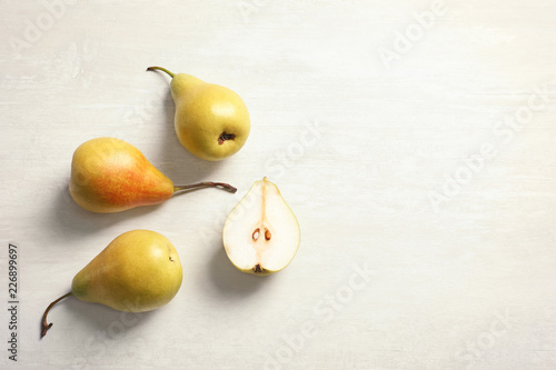 Flat lay composition with ripe pears on light background. Space for text
