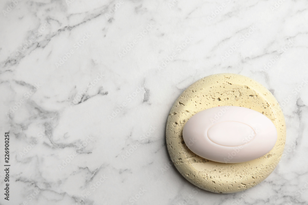 Soap bar and pumice on marble background, top view. Space for text Soap bar and pumice on marble background, top view. Space for text