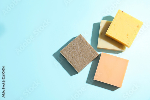Hand made soap bars on color background, top view. Space for text