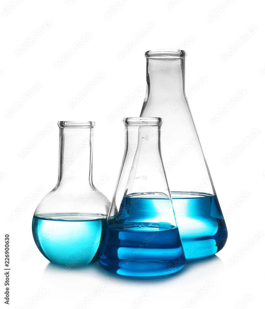 Laboratory glassware with liquid on table against white background. Chemical analysis Laboratory glassware with liquid on table against white background. Chemical analysis