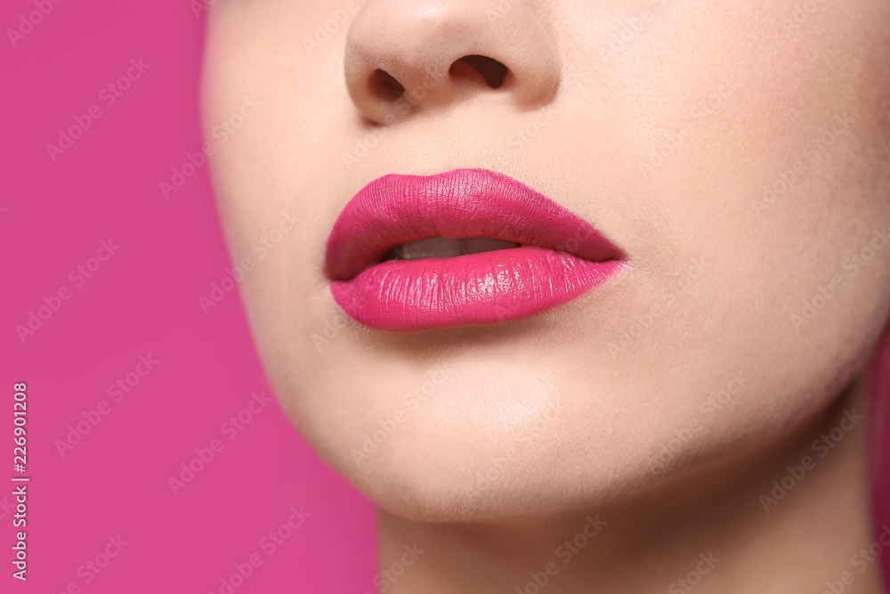 Beautiful young woman with perfect lips makeup on color background, closeup Beautiful young woman with perfect lips makeup on color background, closeup