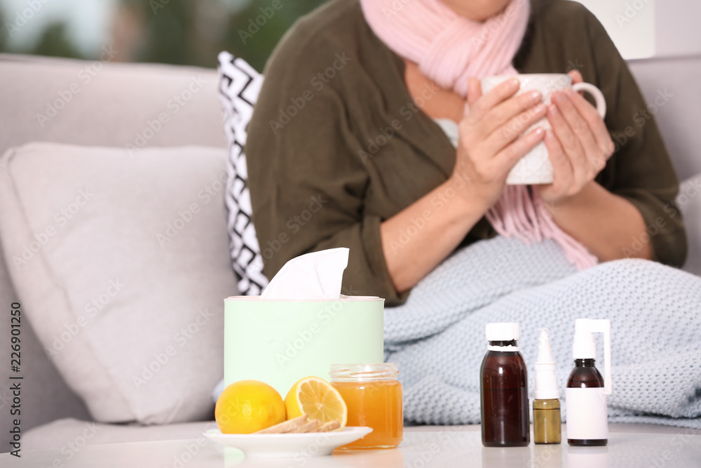Different cough remedies and ill woman on background Different cough remedies and ill woman on background