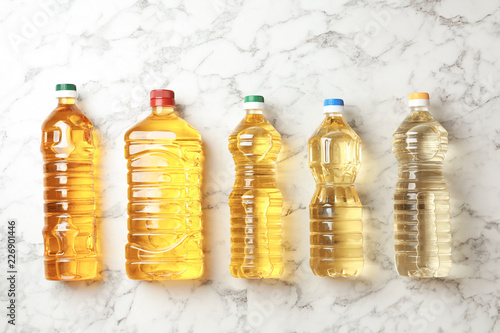 Fototapeta Naklejka Na Ścianę i Meble -  Bottles of oils on marble background, top view