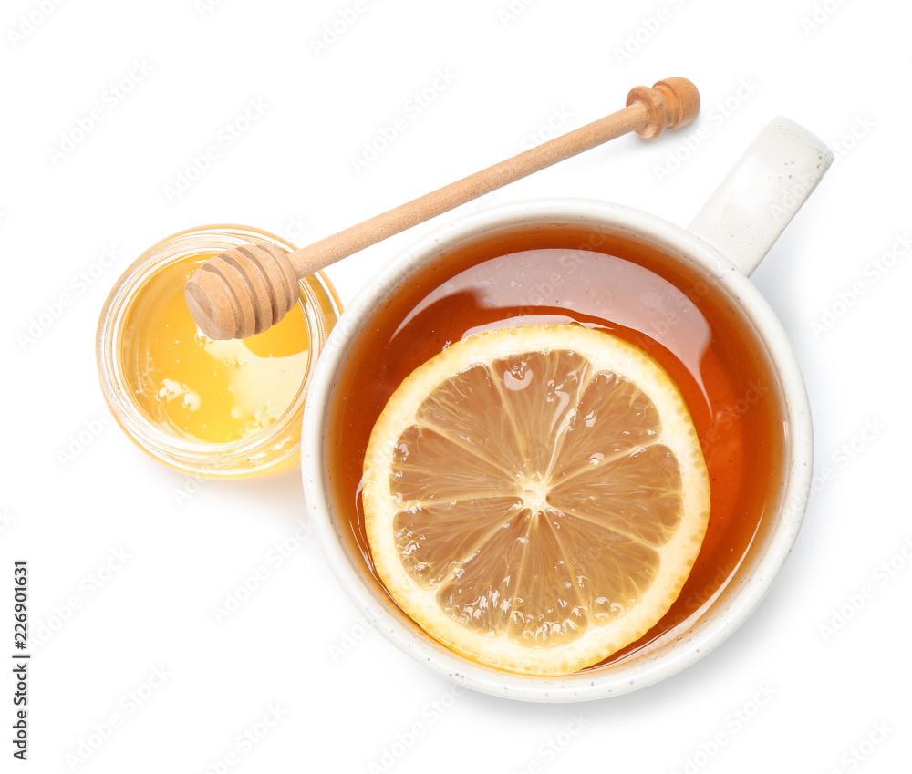 Cup of tea with lemon and honey jar on white background, top view Cup of tea with lemon and honey jar on white background, top view