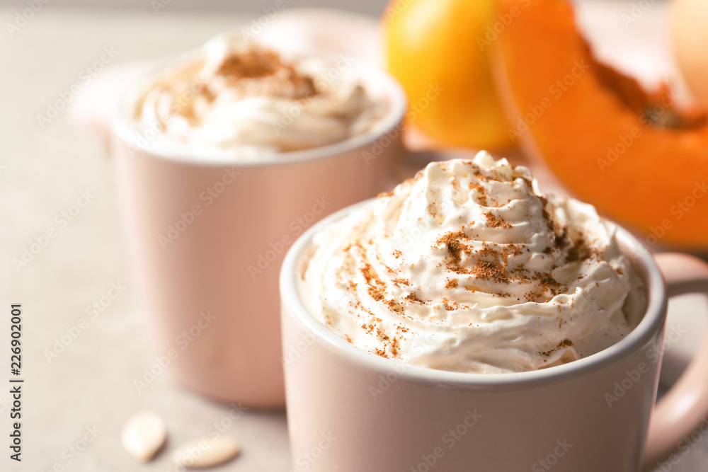 Cup with tasty pumpkin spice latte on gray table, closeup Cup with tasty pumpkin spice latte on gray table, closeup