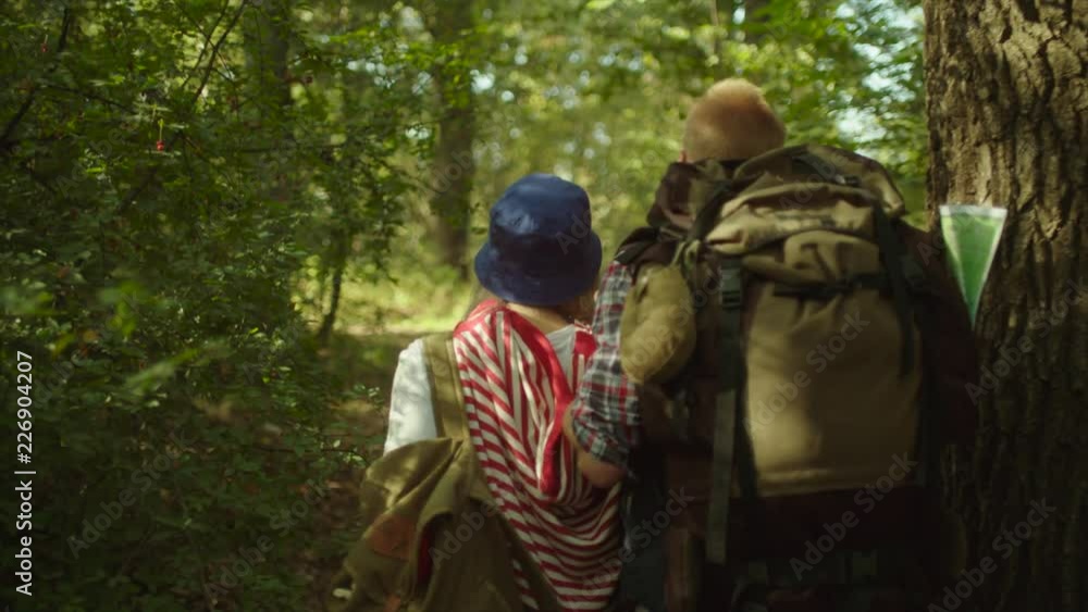 custom made wallpaper toronto digitalYoung couple with backpacks having a walk in the forest